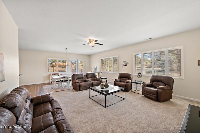 carpeted living room with ceiling fan and a healthy amount of sunlight