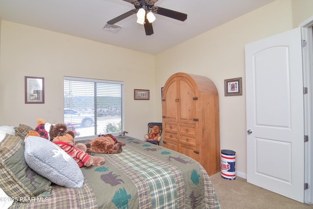 bedroom featuring light carpet, ceiling fan, and arched walkways