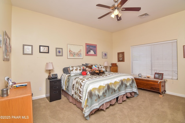 carpeted bedroom featuring baseboards and a ceiling fan