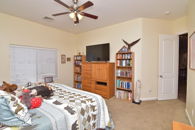 carpeted bedroom with baseboards and a ceiling fan