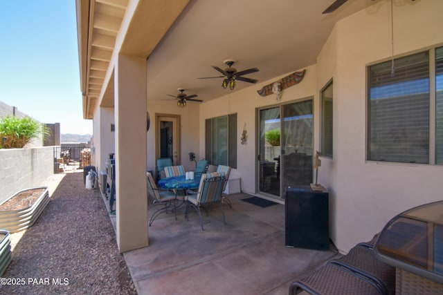 fenced backyard with ceiling fan, a patio area, and outdoor dining area
