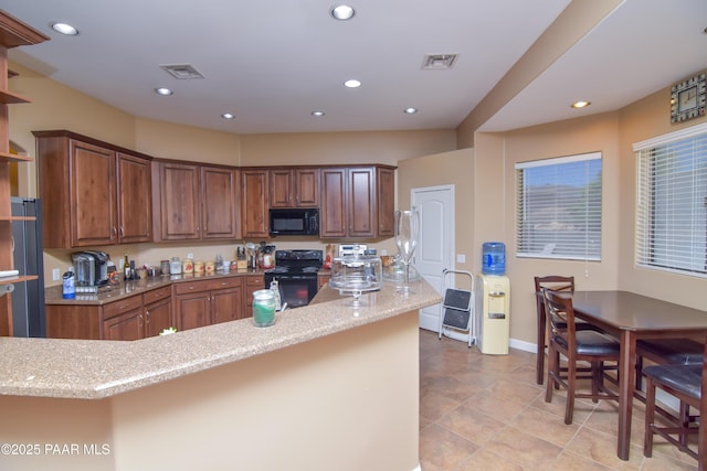 kitchen with black appliances, light stone countertops, recessed lighting, baseboards, and brown cabinetry