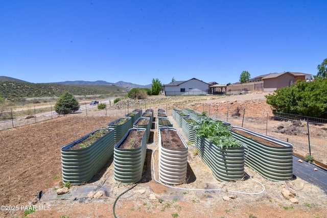 view of yard featuring a vegetable garden and a mountain view