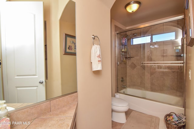 bathroom with toilet, combined bath / shower with glass door, and vanity