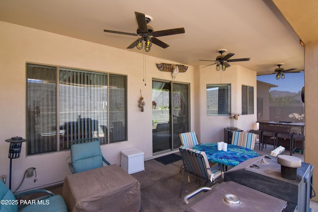 view of patio / terrace featuring outdoor dining area and a ceiling fan