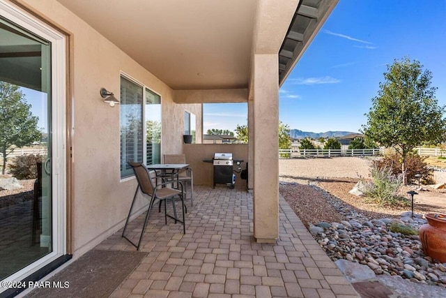 view of patio / terrace featuring a mountain view and area for grilling