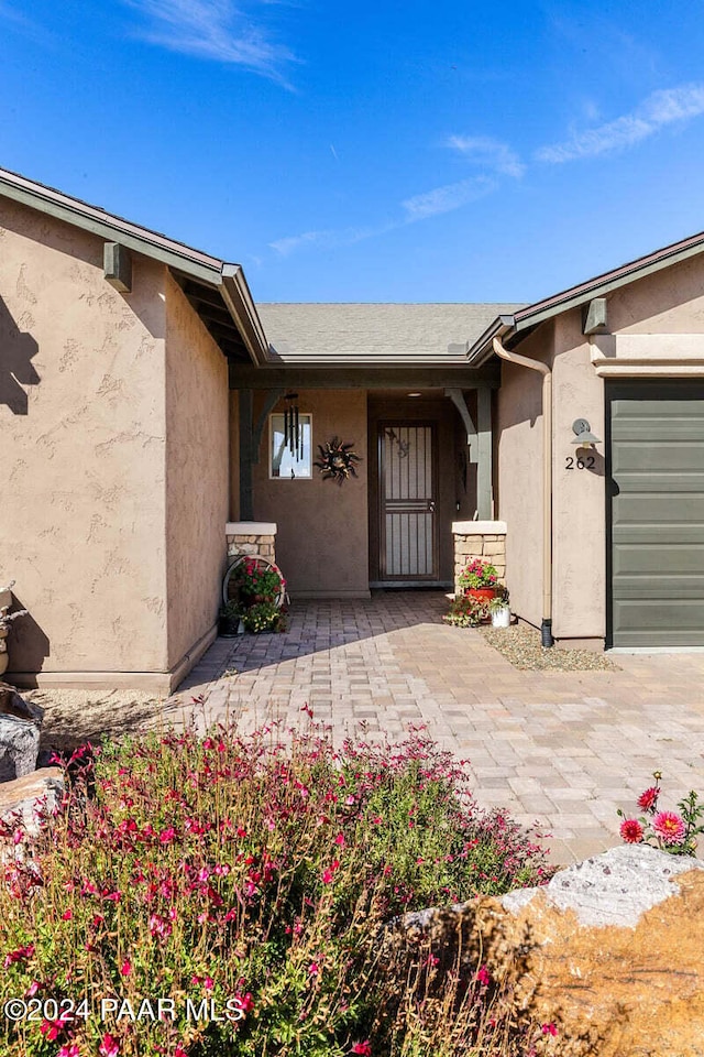 doorway to property featuring a garage