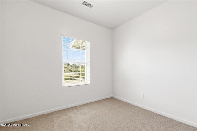 empty room with light carpet and baseboards