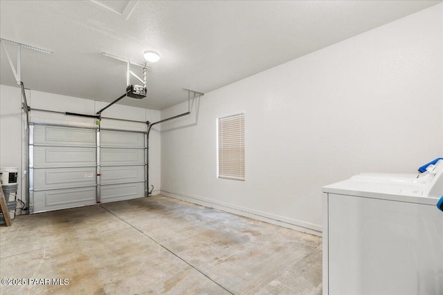 garage featuring independent washer and dryer and a garage door opener