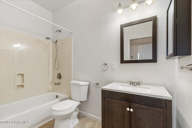 full bath with toilet, vanity, wood finished floors, baseboards, and bathtub / shower combination