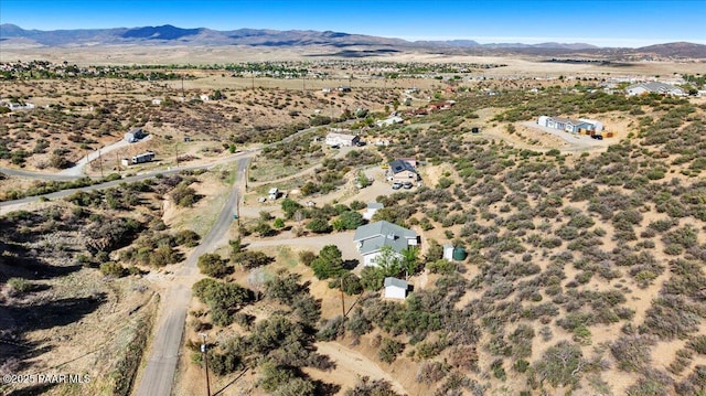 view of property location with a mountainous background, rural landscape, and a desert landscape