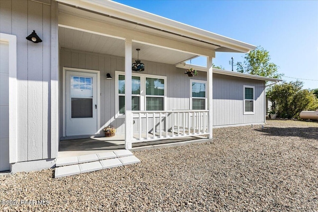 view of exterior entry with a porch