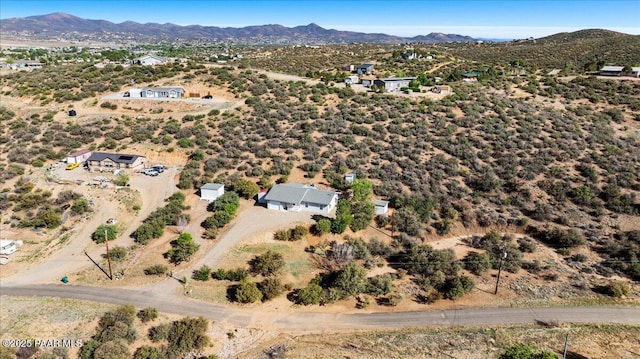aerial view of property and surrounding area with a mountain backdrop
