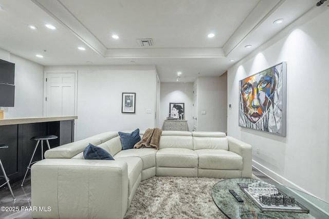 living room with a tray ceiling