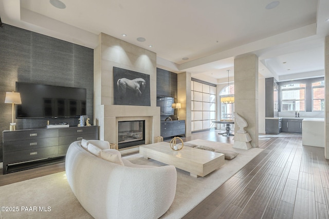 living room with a large fireplace and a chandelier