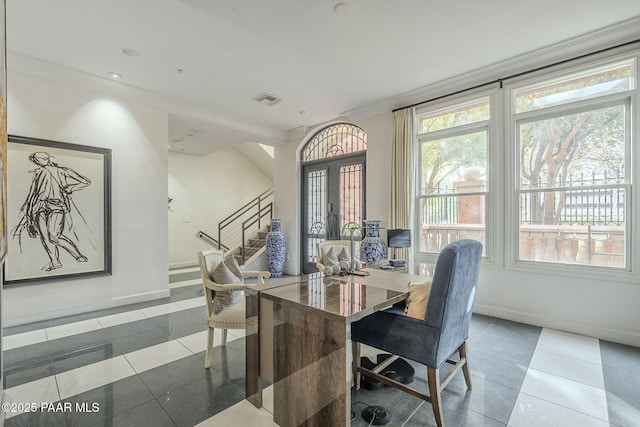 dining room with plenty of natural light, ornamental molding, and tile patterned flooring