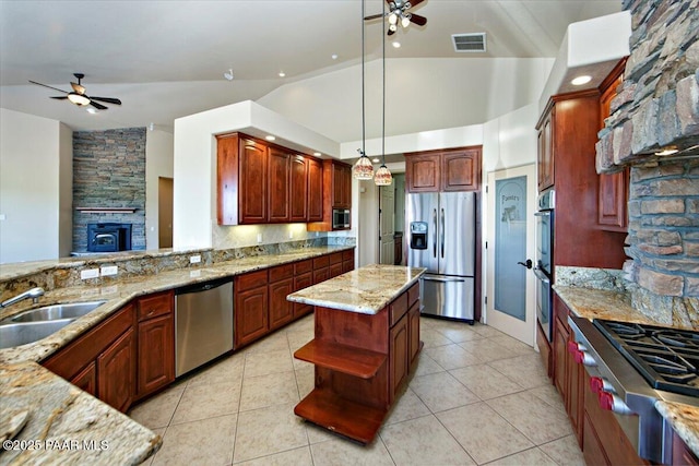 1498 Commonwealth St, Prescott, AZ 86301 - kitchen featuring appliances with stainless steel finishes, ceiling fan, open shelves, light stone counters, and vaulted ceiling