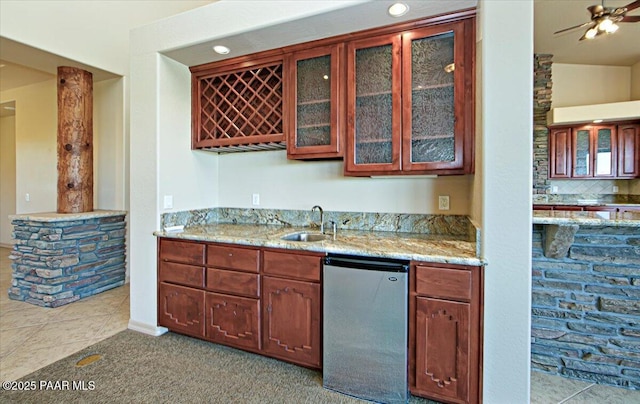 1498 Commonwealth St, Prescott, AZ 86301 - kitchen featuring fridge, light stone counters, glass insert cabinets, tile patterned flooring, and backsplash