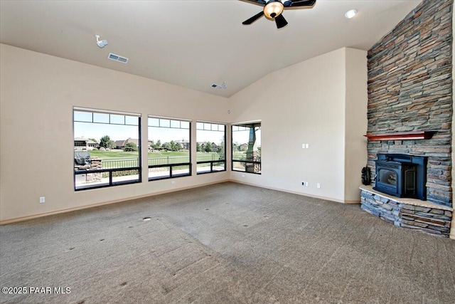 1498 Commonwealth St, Prescott, AZ 86301 - unfurnished living room featuring a ceiling fan, a wood stove, carpet floors, and high vaulted ceiling