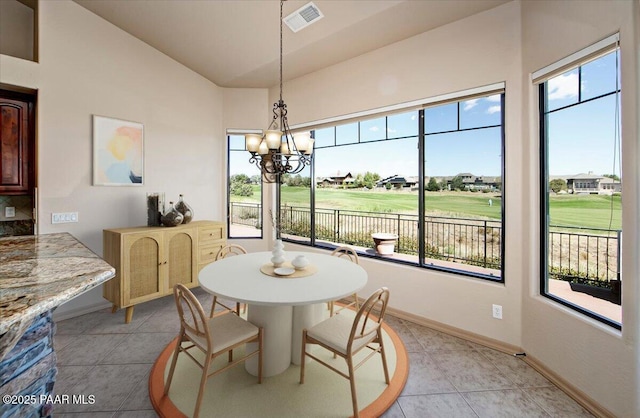 1498 Commonwealth St, Prescott, AZ 86301 - dining space featuring view of golf course, a chandelier, vaulted ceiling, and light tile patterned flooring