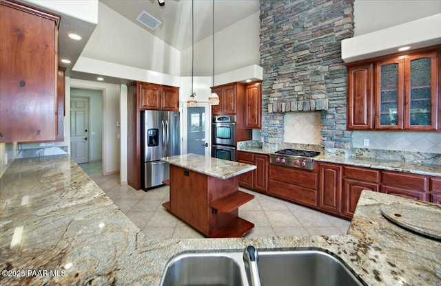 1498 Commonwealth St, Prescott, AZ 86301 - kitchen featuring appliances with stainless steel finishes, light stone counters, light tile patterned floors, backsplash, and high vaulted ceiling