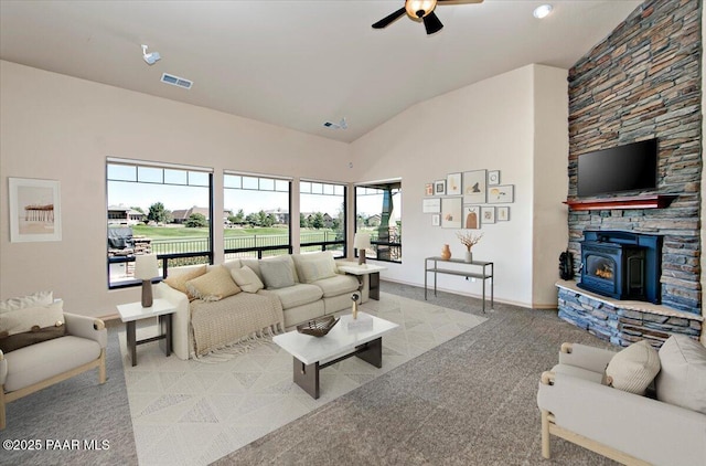1498 Commonwealth St, Prescott, AZ 86301 - living room featuring a ceiling fan, lofted ceiling, carpet flooring, and a wood stove