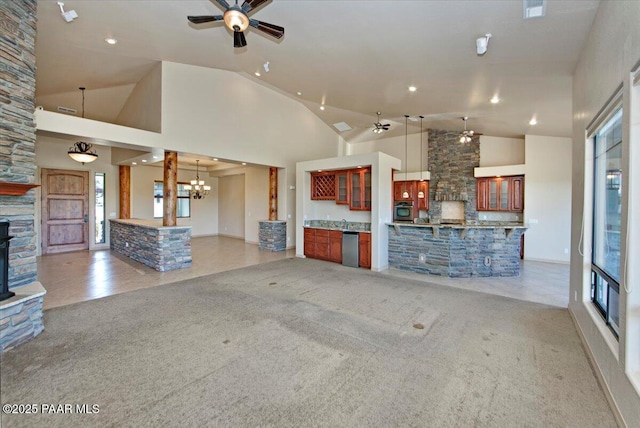 1498 Commonwealth St, Prescott, AZ 86301 - unfurnished living room featuring a ceiling fan, a fireplace, high vaulted ceiling, recessed lighting, and light carpet