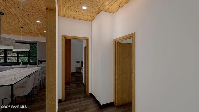 corridor featuring wood ceiling, dark hardwood / wood-style floors, and sink