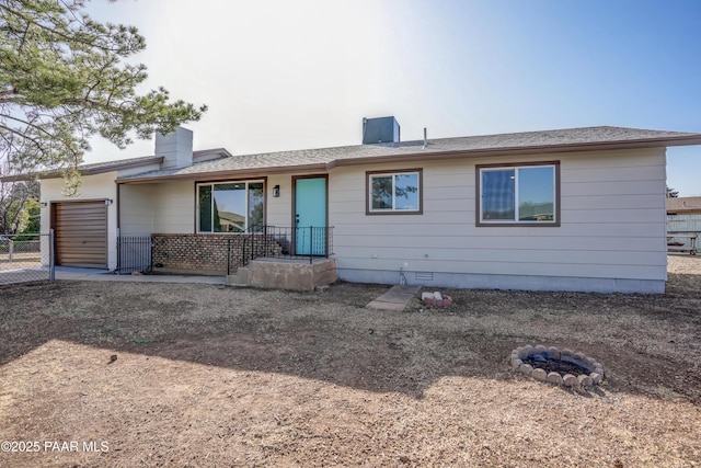 single story home with a garage, fence, dirt driveway, crawl space, and a chimney