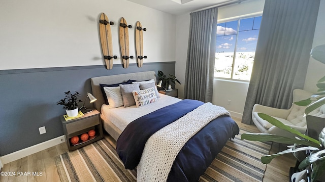 bedroom with hardwood / wood-style floors