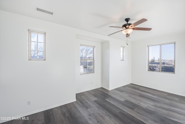 empty room featuring ceiling fan and dark hardwood / wood-style flooring