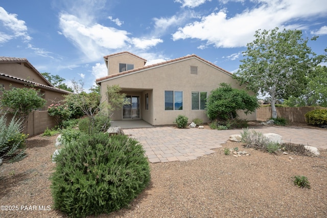 1891 N Tin Strap Trl, Prescott Valley, AZ 86314 - rear view of house featuring stucco siding, a patio area, a fenced backyard, and a tiled roof