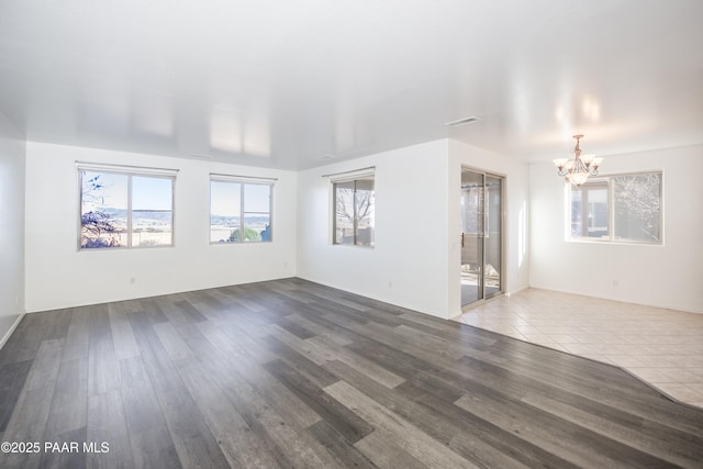 interior space featuring wood-type flooring and a chandelier