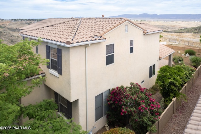 1891 N Tin Strap Trl, Prescott Valley, AZ 86314 - view of side of home featuring stucco siding, a mountain view, and a tiled roof