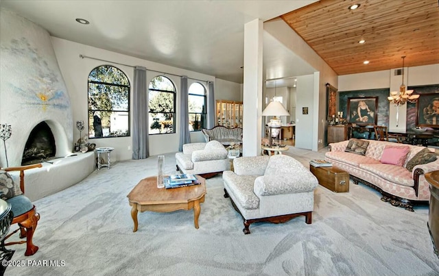 carpeted living room featuring an inviting chandelier, a fireplace, vaulted ceiling, and wooden ceiling