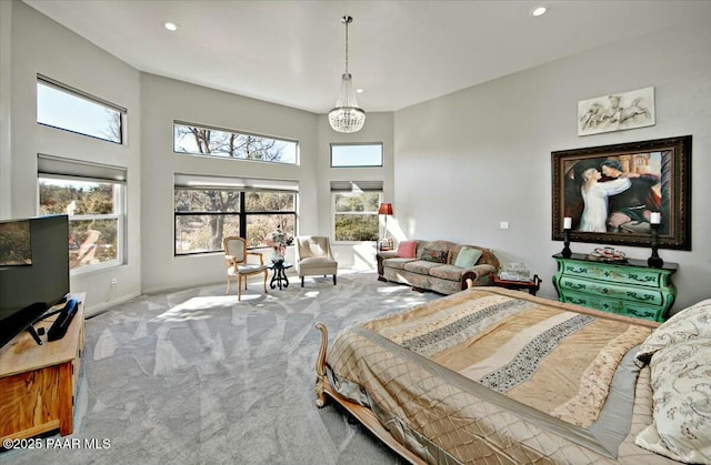 bedroom with light colored carpet and a chandelier