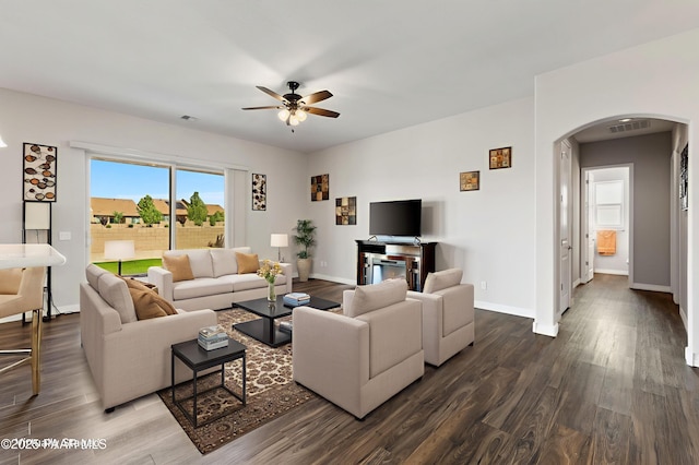 6286 E Livingston Loop, Prescott Valley, AZ 86314 - living room featuring arched walkways, dark wood-style floors, and a ceiling fan