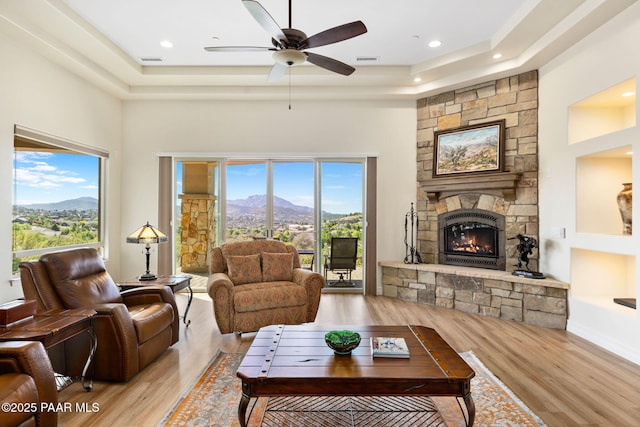 1032 Vantage Point Cir, Prescott, AZ 86301 - living room with a mountain view, a tray ceiling, a stone fireplace, plenty of natural light, and a high ceiling