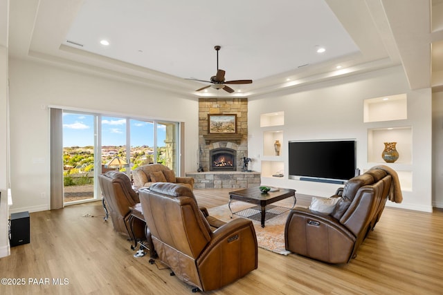 1032 Vantage Point Cir, Prescott, AZ 86301 - living area with a raised ceiling, a ceiling fan, a fireplace, light wood-style flooring, and recessed lighting