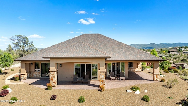 1032 Vantage Point Cir, Prescott, AZ 86301 - back of house featuring stucco siding, stone siding, a patio area, roof with shingles, and a mountain view