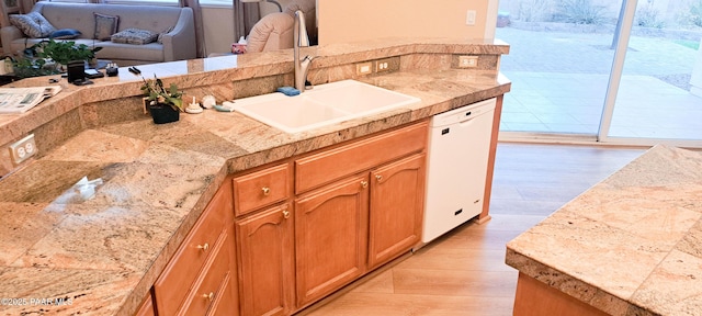 kitchen featuring dishwasher, light hardwood / wood-style flooring, and sink