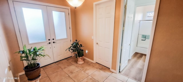 doorway to outside featuring french doors and light tile patterned flooring