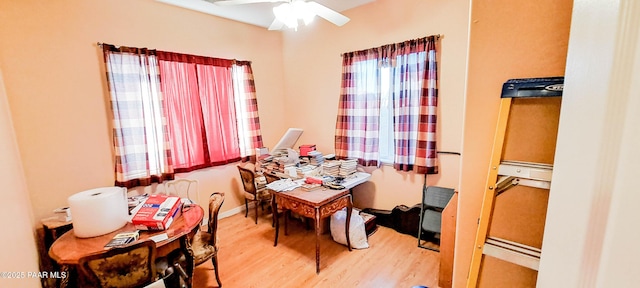 dining area with hardwood / wood-style flooring and ceiling fan