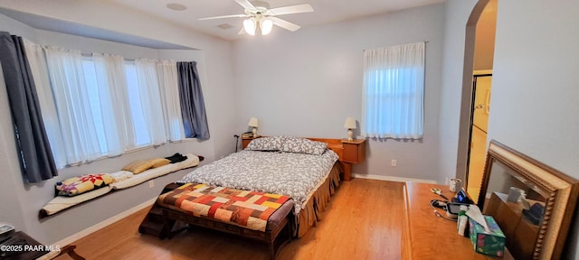 bedroom with hardwood / wood-style floors and ceiling fan