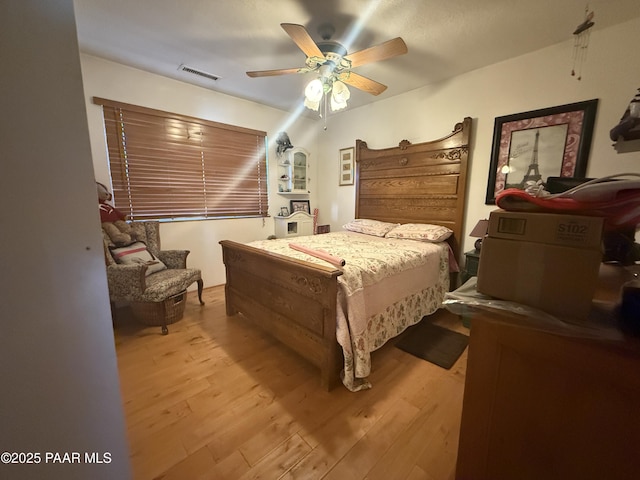 bedroom featuring light hardwood / wood-style flooring and ceiling fan