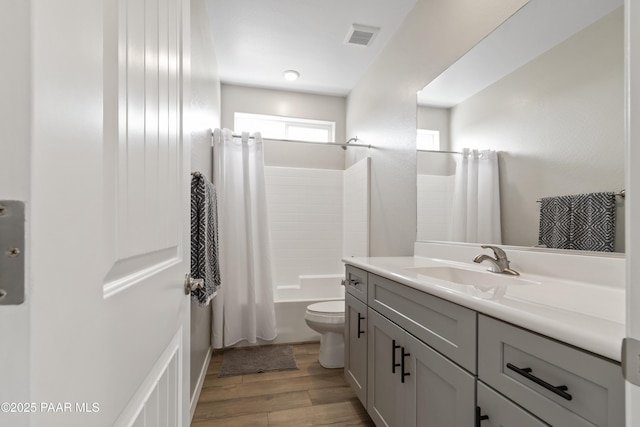 full bathroom featuring shower / tub combo with curtain, vanity, toilet, and hardwood / wood-style floors