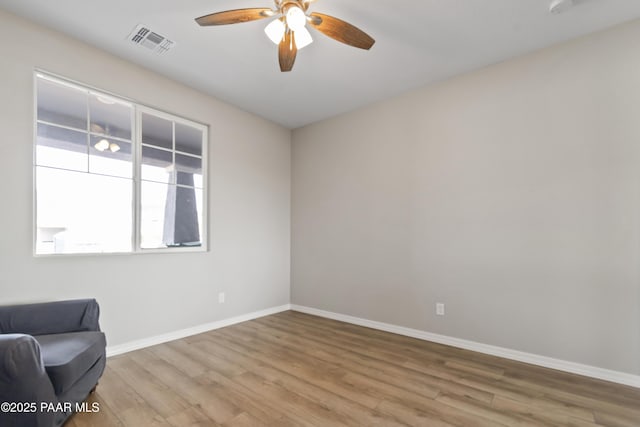 sitting room with ceiling fan and light wood-type flooring