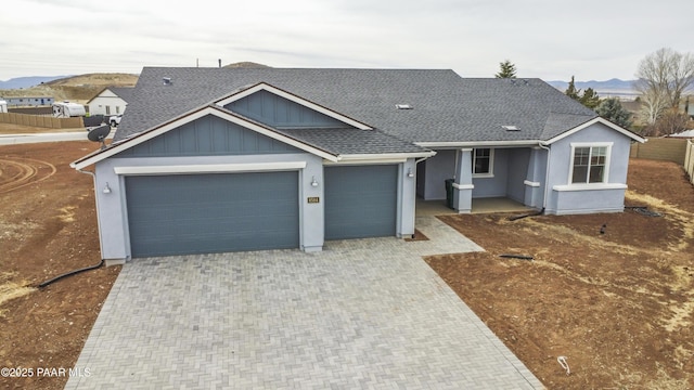 view of front of property featuring a mountain view and a garage