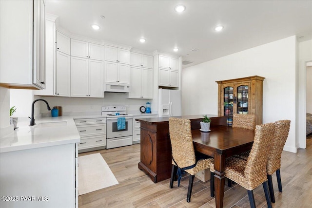 749 S Montezuma St, Prescott, AZ 86303 - kitchen with white appliances, light wood-style flooring, recessed lighting, light countertops, and white cabinetry