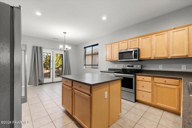 kitchen with hanging light fixtures, light tile patterned floors, a notable chandelier, a kitchen island, and stainless steel appliances